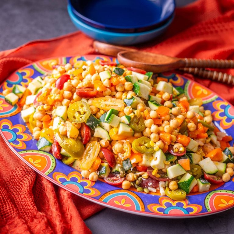 Mexican Chickpea Salad on a talavera platter with orange textile.