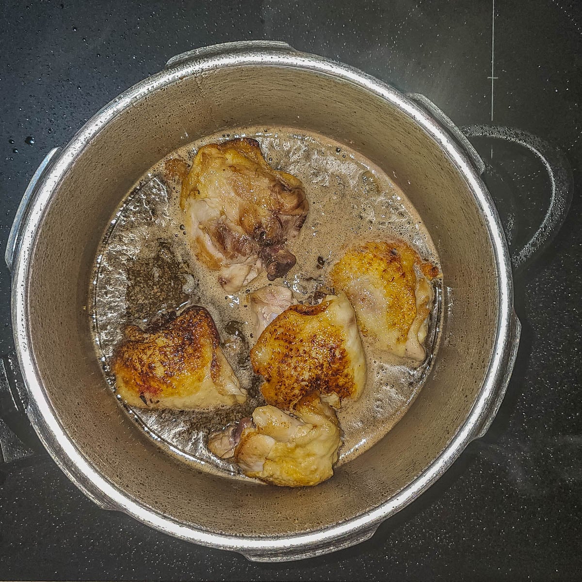 Step 3 - Add the beer, broth, aromatics, and spices to the pot.