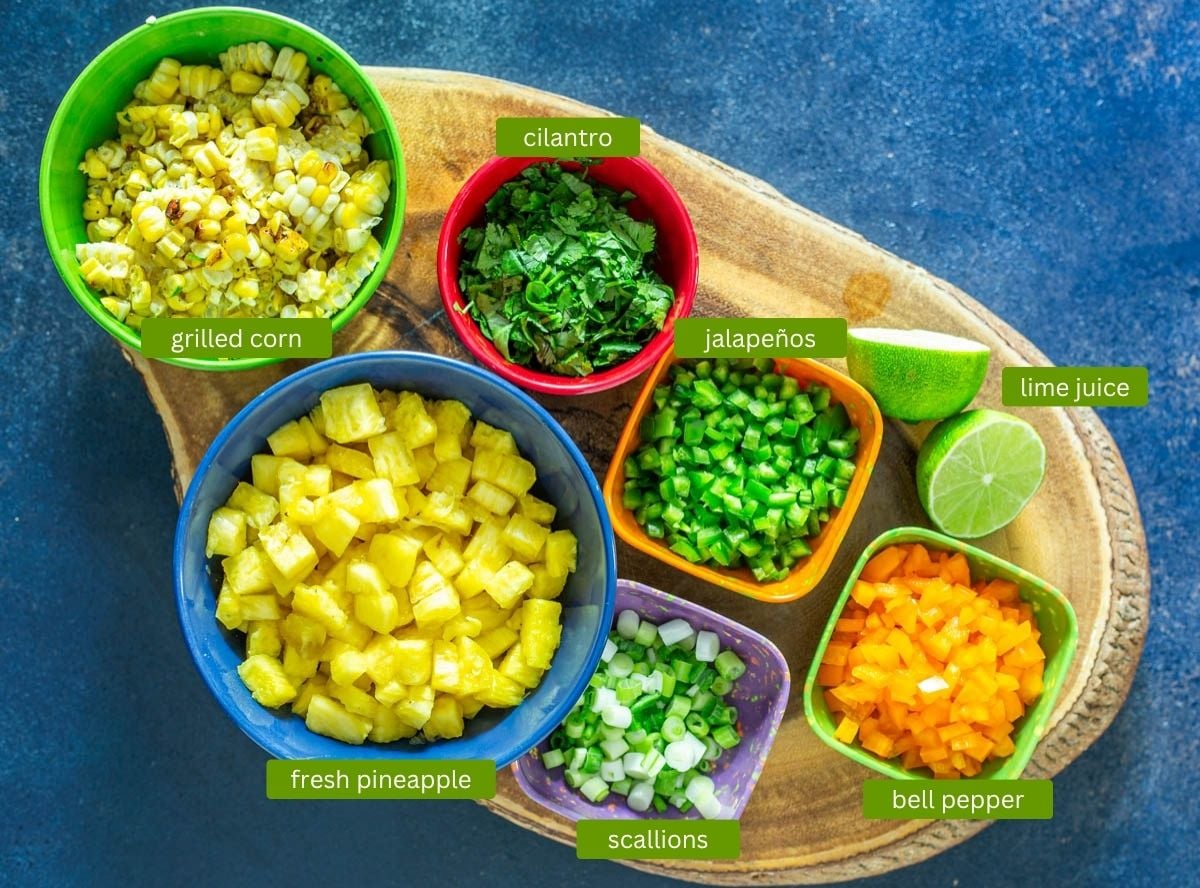 Ingredients for grilled corn and pineapple salsa including diced fresh pineapple and grilled fresh corn kernels.