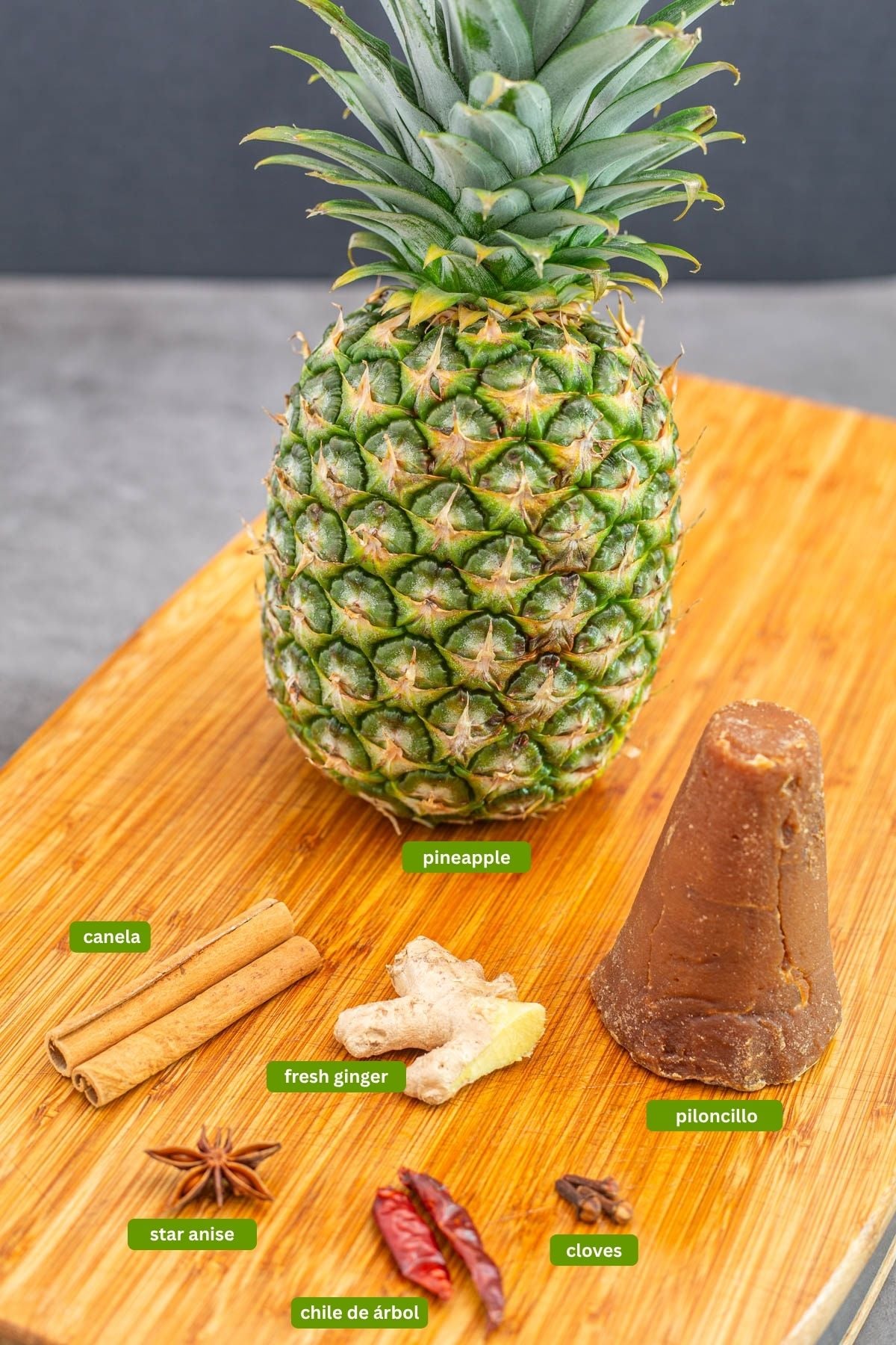 Ingredients for homemade tepache including pineapple, spices, and piloncillo sugar.