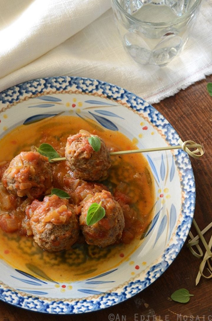 Tomato, lemon, and oregano ground bison meatballs in a fine china shallow bowl.