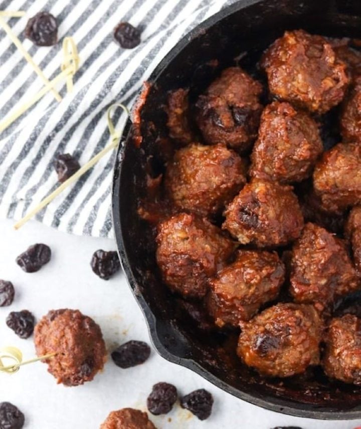 A cast iron skillet with healthy ground bison and cherry meatballs.