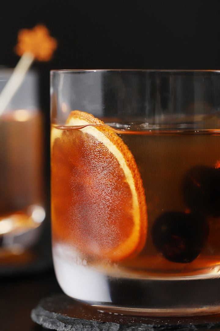 A close up of a creative maple old fashioned with orange slice.